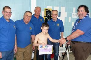 Jack Flint of the Cubs receiving His one mile ASA Rainbow certificate from David Clifton Scout Cub 